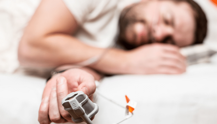Man Sleeping, Taking Home Sleep Apnea Test